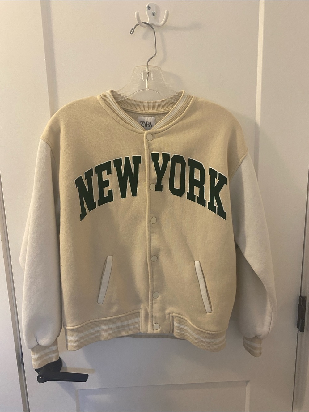 Size 13/14 Zara Kids Cream & White 'New York' Varsity Jacket with Green Letters